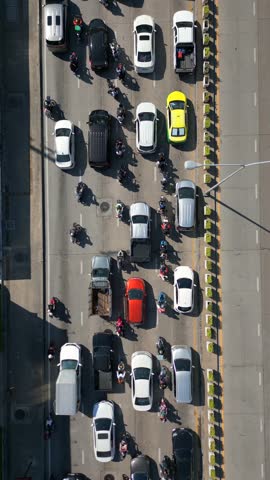 Aerial top-down view of busy traffic with cars and motorbikes in Bangkok, Thailand. Dynamic city traffic showing movement and daily urban life in Asia.