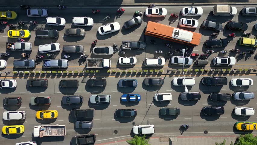 Aerial view of massive traffic jam in Bangkok, Thailand. Packed lanes of cars, buses, and motorbikes showing daily rush hour and urban life in Asia.