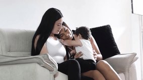 Cozy family moments: Latin lesbian couple with their baby on their legs watch her with tenderness - Powered by Shutterstock - Get 15% off with code: PIKWIZARD15