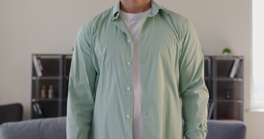 Torso view of man crossing arms into a cross sign, a firm gesture that communicates rejection and stop at home bu hands. He marks boundary to refuse and deny. Clear warning signal in nonverbal form.