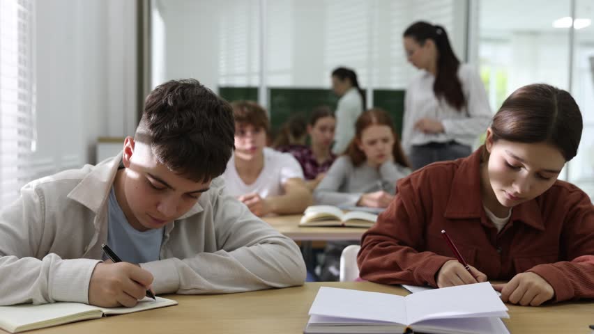 Teacher and students during lesson in classroom, selective focus