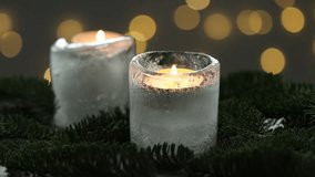 DIY Christmas lantern. Woman taking burning ice candle and fir branches at table against grey background with blurred lights, closeup. Bokeh effect - Powered by Shutterstock - Get 15% off with code: PIKWIZARD15