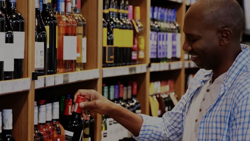 Mature shopper reaching bottle in wine aisle to read label, animated magnifier highlighting label. Liquor, retail, shelves, wooden, warm, curious, inspection