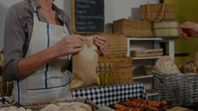Customer reaching to pay, shopkeeper opening brown bag at bakery, handing while inspecting order. Counter, apron, striped, rustic, wicker, baskets, bread - Powered by Shutterstock - Get 15% off with code: PIKWIZARD15