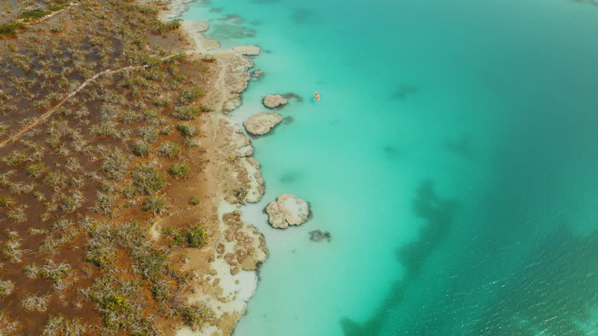 Kayakers floating on turquoise water near stromatolites at Los Rapidos Bacalar Mexico