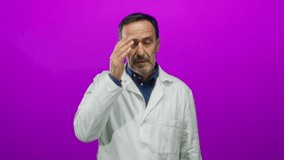 Hispanic man in white coat looks surprised against isolated pink background, capturing expression and emotion vividly. - Powered by Shutterstock - Get 15% off with code: PIKWIZARD15