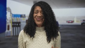 African american woman scrunches nose at fuel pump and waves palms forward at petrol station; disgust. - Powered by Shutterstock - Get 15% off with code: PIKWIZARD15