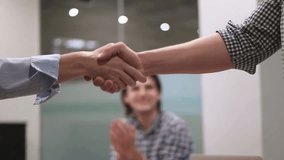 Businesswoman shaking hands with a partner in a professional setting, symbolizing agreement, collaboration, partnership, and corporate success. - Powered by Shutterstock - Get 15% off with code: PIKWIZARD15