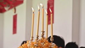 Light candles in Buddhist temple, Thailand. They're often placed in front of Buddhist shrines as a mark of respect or deference. - Powered by Shutterstock - Get 15% off with code: PIKWIZARD15