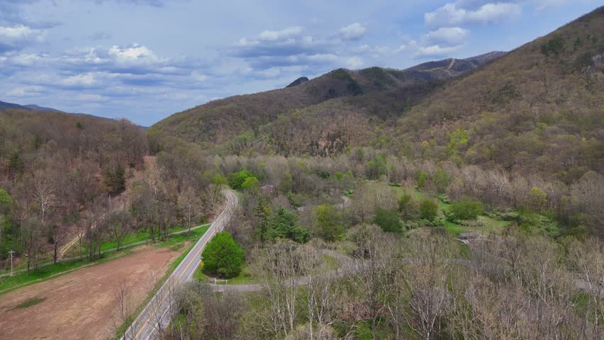 Scenic valley road leading toward forested Seneca Rocks mountain range, West Virginia, USA