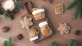 Christmas gingerbread cookies shaped as snowflakes mitten stocking gift and star on wooden board with fir branches - Powered by Shutterstock - Get 15% off with code: PIKWIZARD15