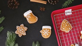 Christmas gingerbread cookies arranged with pine cones and pine branches on dark surface - Powered by Shutterstock - Get 15% off with code: PIKWIZARD15