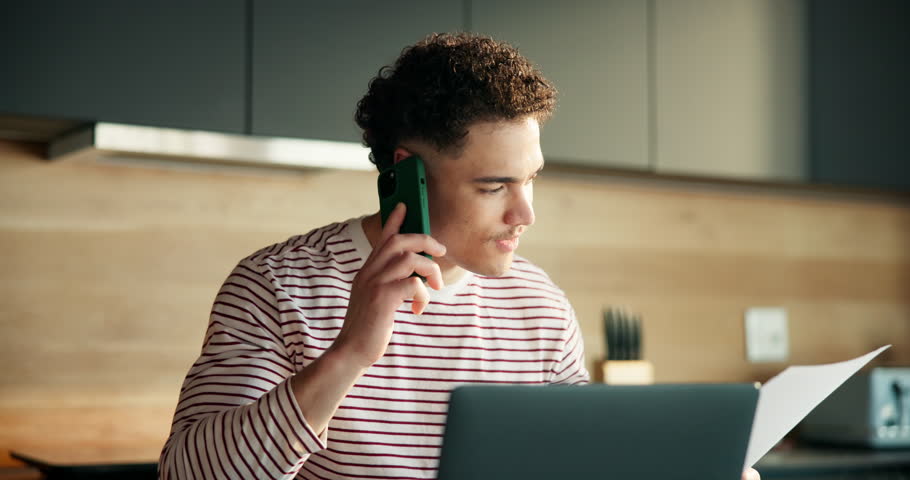 Phone call, documents and laptop with man in kitchen for networking, project consultant and talking. Virtual advisor, discussion and planning with person in home for remote work, feedback and chat