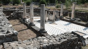 Scenic summer view of archaeological site of Heraclea Lyncestis near Bitola, North Macedonia, overlooking ruins of ancient layered stone walls, marble columns, and surrounding greenery - Powered by Shutterstock - Get 15% off with code: PIKWIZARD15