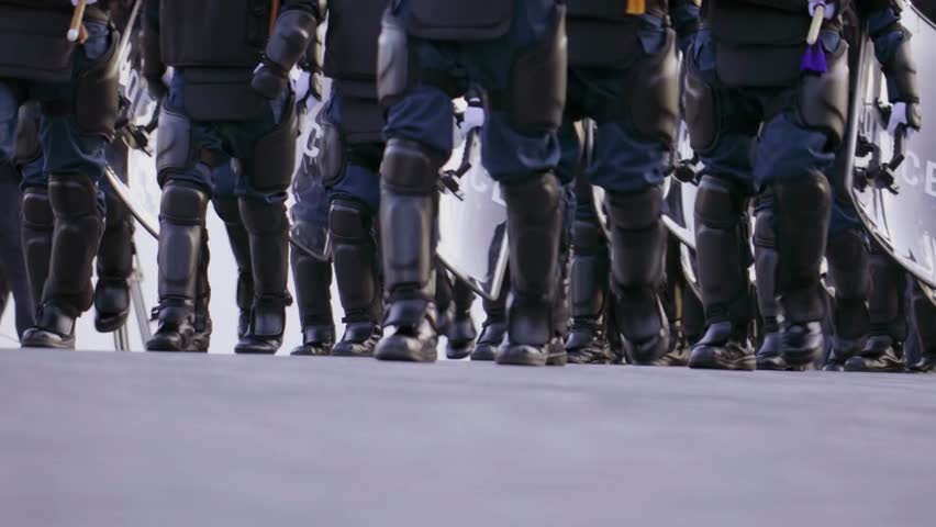 Police soldiers with riot shields. guarded government during protests strikes rebellion day Close up