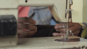 Close-up of the hands of an Afro-Colombian woman sewing homemade fabric face masks to survive economically while living in a parking lot during the COVID-19 lockdown in Bogotá. - Powered by Shutterstock - Get 15% off with code: PIKWIZARD15