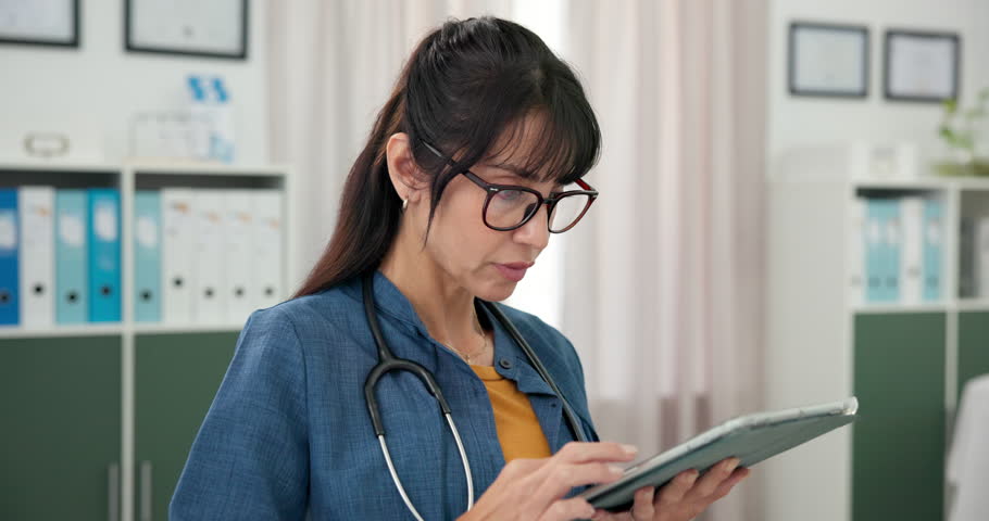 Doctor, medical research and woman with tablet, hospital and reading diagnosis on website or online. Review, test results and mature person with tech for healthcare, browsing and patient records