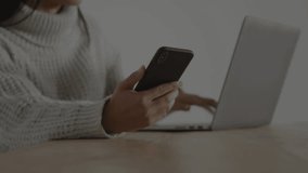 Woman using phone and laptop, tapping phone making finance charts showing percent rise for trading. Smartphone, computer, markets, candlestick, graphs, investing, focus - Powered by Shutterstock - Get 15% off with code: PIKWIZARD15