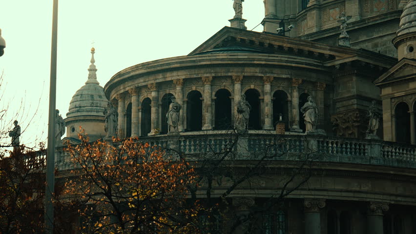 Close-up view of St. Stephen’s Basilica in Budapest, showing ornate stone columns and statues on a calm daylight scene.