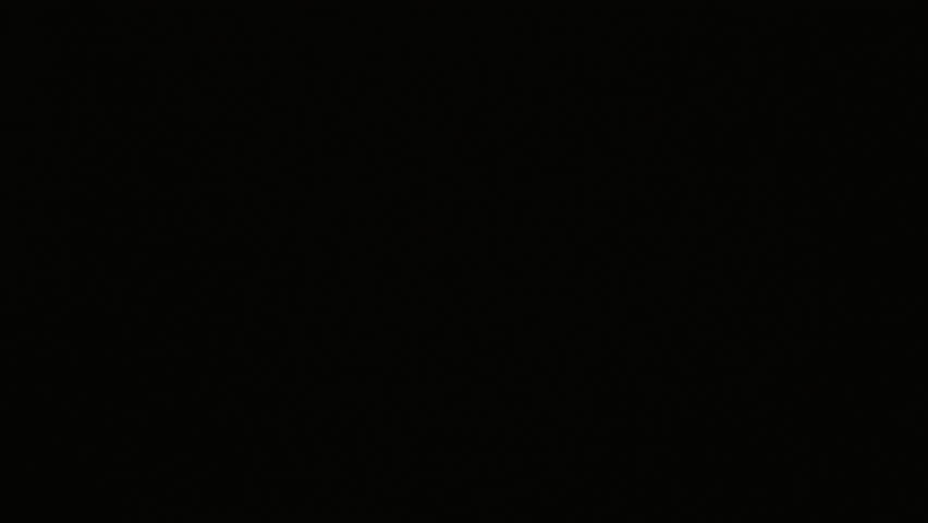 View from below of adult Caucasian joyful woman unboxing present with handmade candle and candleholder indoors