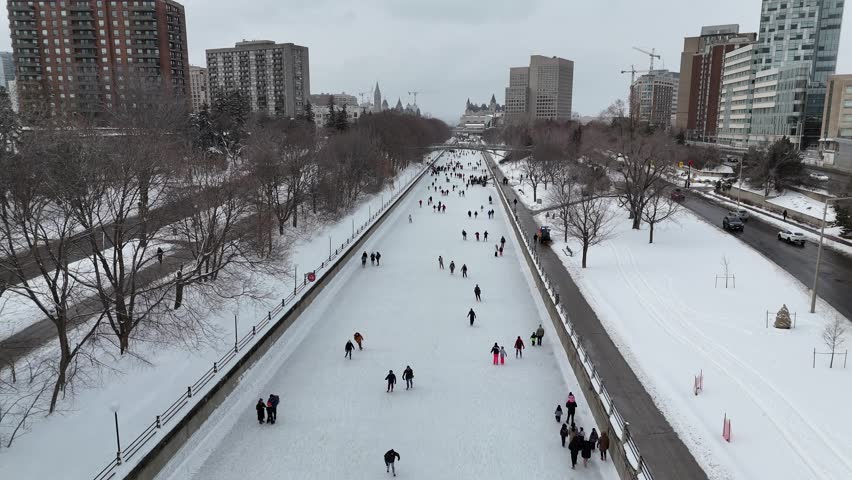 Aerial views of skaters enjoying the iconic Rideau Canal Skateway on a snowy day in Ottawa, Ontario, Canada.