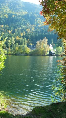 Autumn mountain landscape, mountains near lake, reflections in the water.