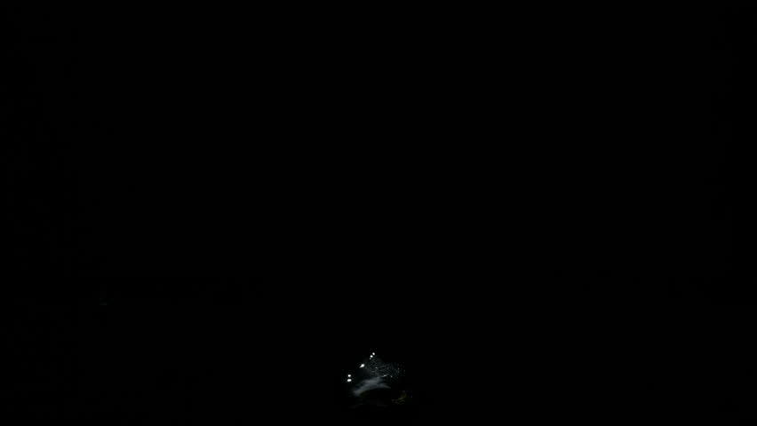Super Slow Motion Shot of Real Water Splash from Surface Isolated on Black at 1000fps.