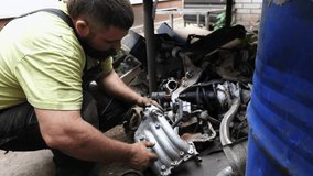 Skilled automotive mechanic engaged in detailed car repair, meticulously assembling components in garage environment, showcasing the intricate process of automotive maintenance and craftsmanship - Powered by Shutterstock - Get 15% off with code: PIKWIZARD15