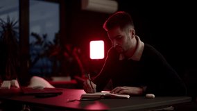 A young man writing in a notebook at a cozy home desk, journaling in warm evening light. Calm atmosphere, self-reflection, focus, and quiet lifestyle moments in a comfortable living room. - Powered by Shutterstock - Get 15% off with code: PIKWIZARD15