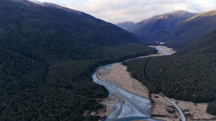 River flowing through valley in Mount Aspiring National Park, South Island, New Zealand. Aerial drone