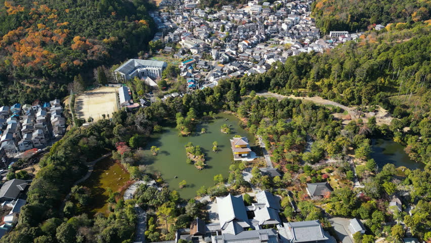 Aerial view circling the Kinkaku-ji temple, sunny, fall day in Kyoto, Japan