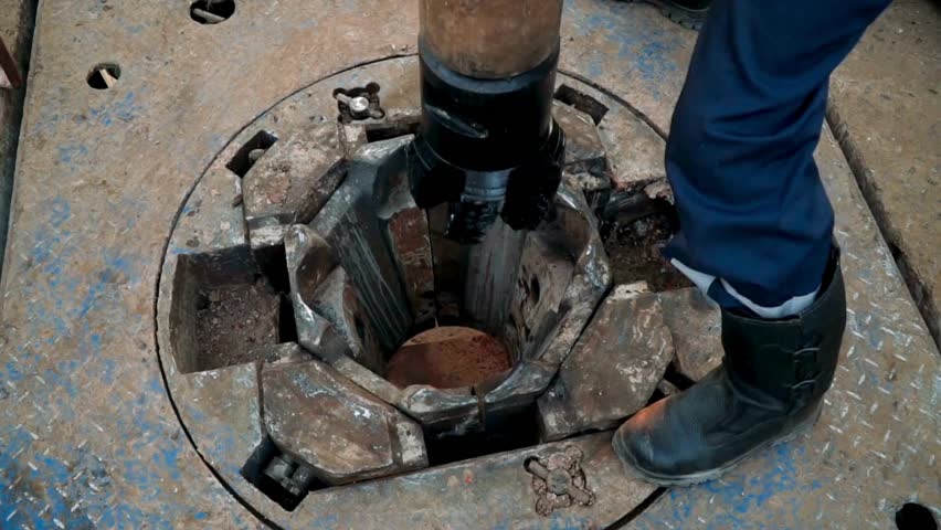 Detailed look at offshore oil rig operations during active drilling. Footage captures the intricate machinery and workers operating heavy equipment, emphasizing energy production dynamics.