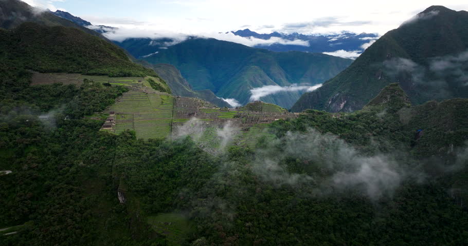 Machu Picchu ruins UNESCO world heritage site atop ridge in Andes, Peru. Aerial