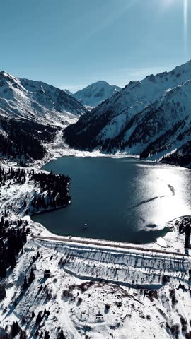 Aerial view of mountain lake at winter with snow