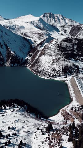 Aerial view of mountain lake at winter with snow