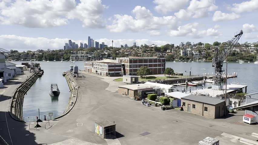 Wide shot of the harbour port area looking towards the CBD city on the historical industrial Cockatoo Island in Sydney harbour, Australia