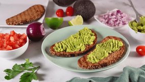 A stunning 4K close-up video showing a person preparing a quick and healthy meal of avocado toast, spreading the avocado on bread and garnishing it with seasonings. - Powered by Shutterstock - Get 15% off with code: PIKWIZARD15
