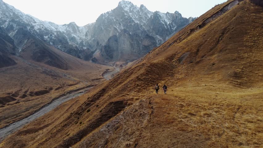 Hiker ascending a rugged mountain slope