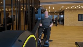 Elderly Caucasian Man Exercising On A Rowing Machine For Health And Wellness In A Indoor Gym. - Powered by Shutterstock - Get 15% off with code: PIKWIZARD15