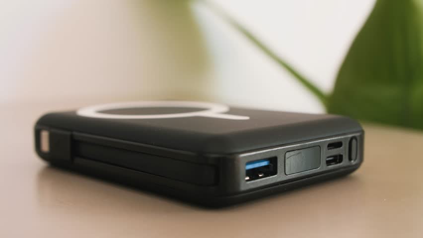 Smartphone with wireless charging. Close-up of a mobile phone charging. Powerbank and phone close up. High quality 4k footage