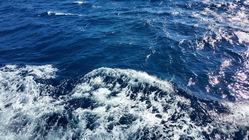 Dynamic ocean waves crashing against the shore captured in high definition.