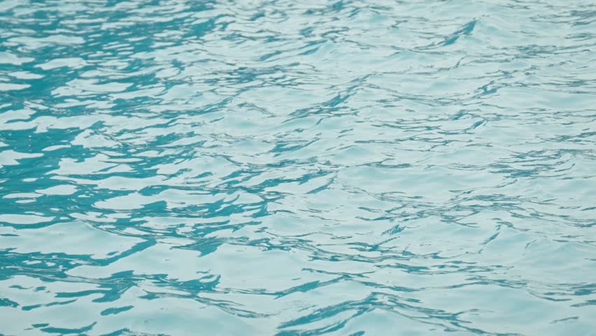 Slow motion of gentle ripples and light reflections moving across lake surface at Ohori Park, Fukuoka, Japan, conveying calm energy and peaceful minimal beauty