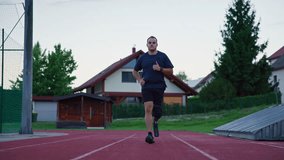 Sports activities on a track, an amputee male athlete using an orthopedic mobility aid, a running blade prosthesis during training, front view. - Powered by Shutterstock - Get 15% off with code: PIKWIZARD15