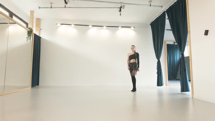 Low angle view of skilled girl doing acrobatic handstand in a studio - Powered by Shutterstock - Get 15% off with code: PIKWIZARD15