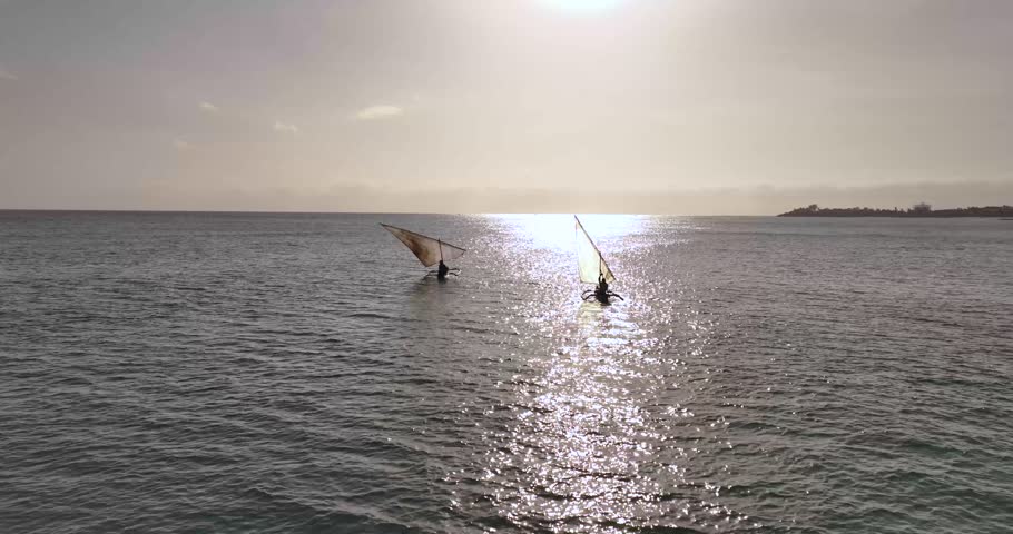 A drone shot of two Dhow boats on the coast of Mozambique in Cabo Delgado at sunset