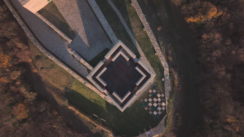 Aerial drone top-down rotation and ascent over Medvedgrad fortress main tower and Altar of the Homeland in golden hour, Zagreb, Croatia