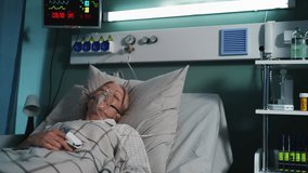 Weak senior woman wearing oxygen mask in ICU room, connected to life support - Powered by Shutterstock - Get 15% off with code: PIKWIZARD15