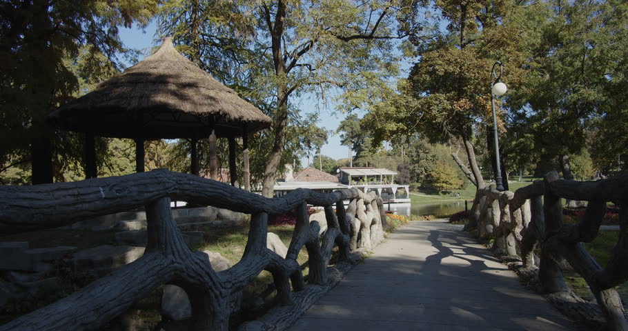 Gazebo and bridge over lake in the park 4K footage