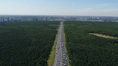 Drone Flying above Forest Highway Heavy Traffic