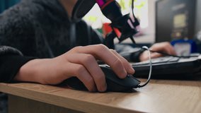 Hand on mouse teen boy gamer play video game on PC, closeup shot - Powered by Shutterstock - Get 15% off with code: PIKWIZARD15